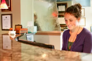 smiling woman at reception desk